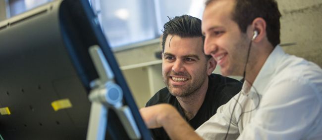 Developers looking at computer screen