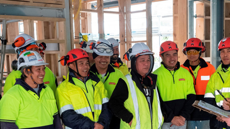 Group of construction workers onsite with manager