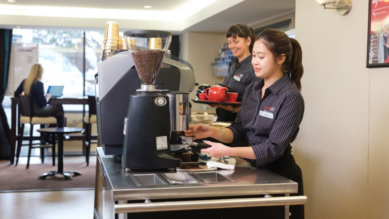 Two barristers making coffee in a cafe