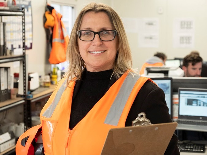 A female construction worker in her office