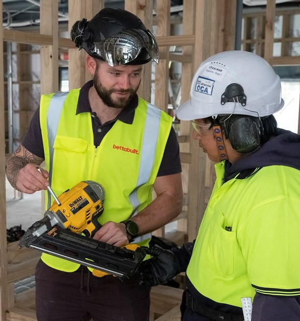 Supervisor showing a worker how to use some equipment