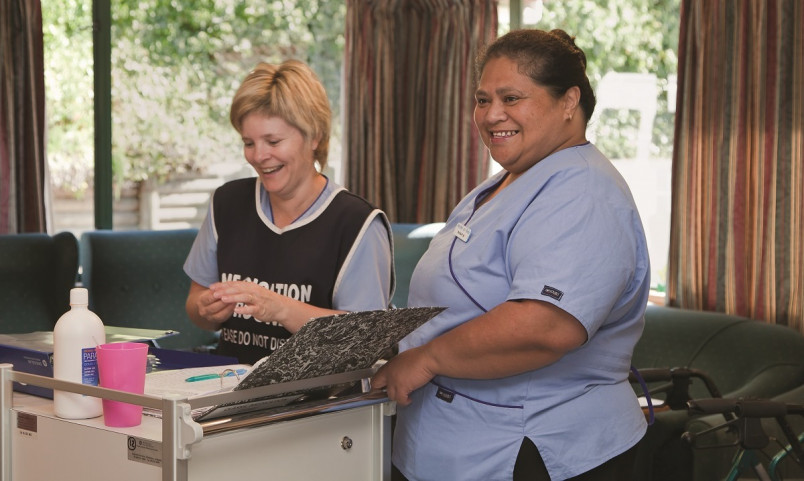 Migrant nurse and "Kiwi" nurse smiling and laughing in office