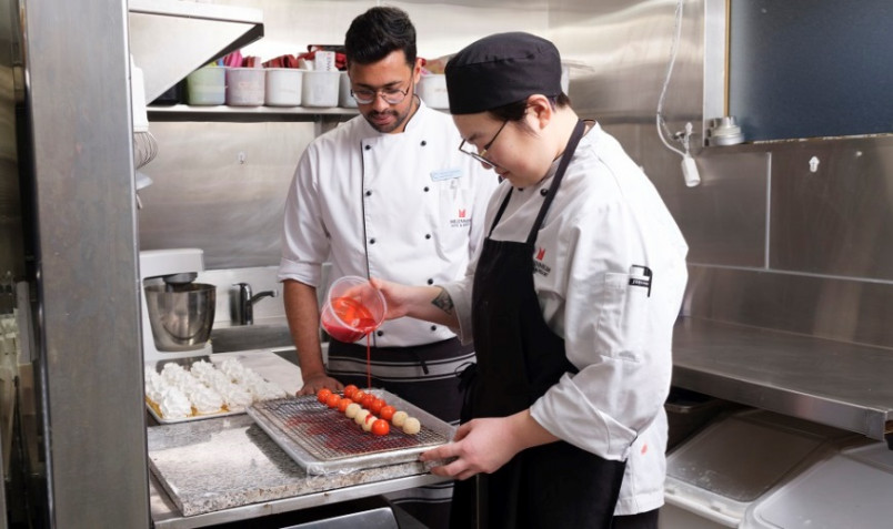 Migrant pastry chefs making a dessert