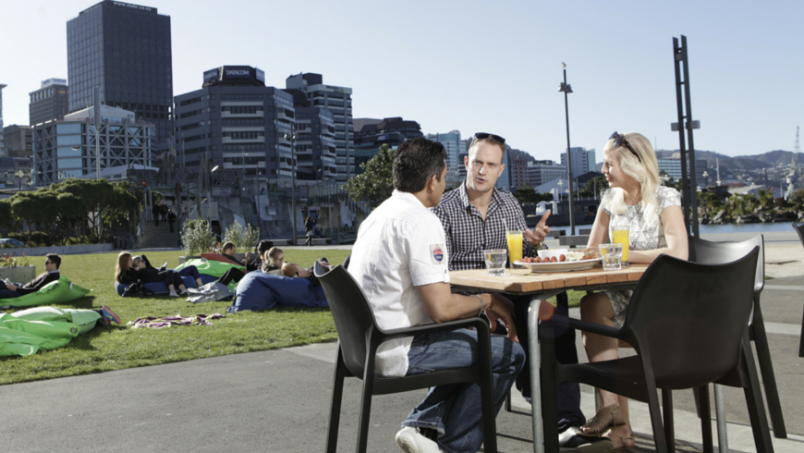 Family sitting outside in New Zealand discussing