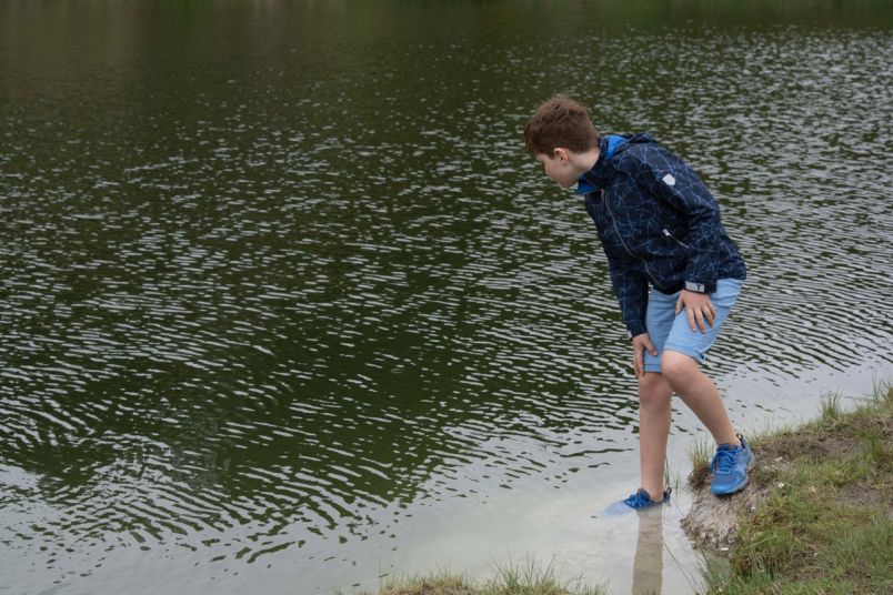 Kid by water